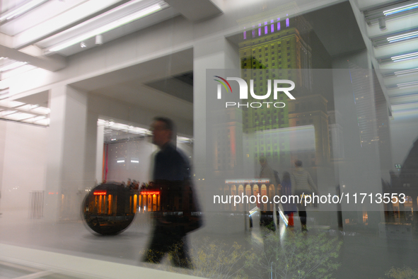 Visitors are seen refelcted in a window at the opening of the new Museum of Modern Art (Muzeum Sztuki Nowoczesnej) in Warsaw, Poland on 25 O...