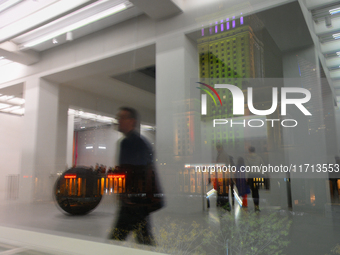 Visitors are seen refelcted in a window at the opening of the new Museum of Modern Art (Muzeum Sztuki Nowoczesnej) in Warsaw, Poland on 25 O...