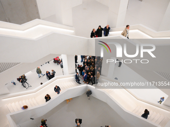 Visitors are seen on the evening of the opening of the new Museum of Modern Art (Muzeum Sztuki Nowoczesnej) in Warsaw, Poland on 25 October,...