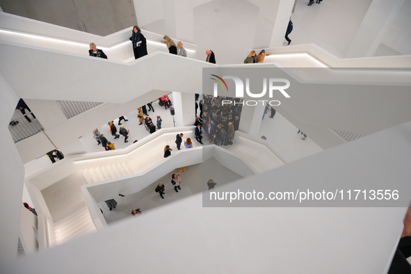 Visitors are seen on the evening of the opening of the new Museum of Modern Art (Muzeum Sztuki Nowoczesnej) in Warsaw, Poland on 25 October,...