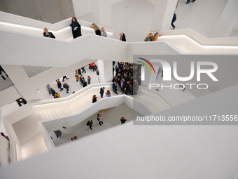 Visitors are seen on the evening of the opening of the new Museum of Modern Art (Muzeum Sztuki Nowoczesnej) in Warsaw, Poland on 25 October,...