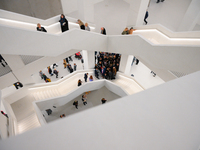 Visitors are seen on the evening of the opening of the new Museum of Modern Art (Muzeum Sztuki Nowoczesnej) in Warsaw, Poland on 25 October,...