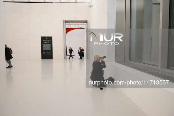 A photographer is seen at the opening of the new Museum of Modern Art (Muzeum Sztuki Nowoczesnej) in Warsaw, Poland on 25 October, 2024. 