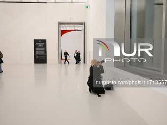 A photographer is seen at the opening of the new Museum of Modern Art (Muzeum Sztuki Nowoczesnej) in Warsaw, Poland on 25 October, 2024. (