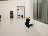 A photographer is seen at the opening of the new Museum of Modern Art (Muzeum Sztuki Nowoczesnej) in Warsaw, Poland on 25 October, 2024. (