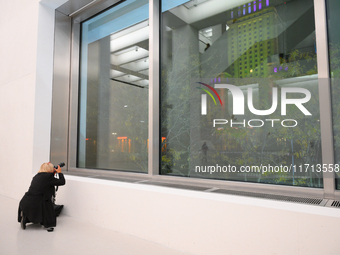 A photographer is seen at the opening of the new Museum of Modern Art (Muzeum Sztuki Nowoczesnej) in Warsaw, Poland on 25 October, 2024. (