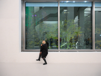 A photographer is seen at the opening of the new Museum of Modern Art (Muzeum Sztuki Nowoczesnej) in Warsaw, Poland on 25 October, 2024. (