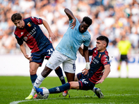 Boulaye Dia of SS Lazio is challenged by Fabio Miretti of Genoa CFC and Johan Vasquez during the Serie A Enilive match between SS Lazio and...