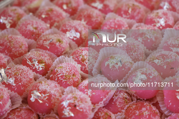 Chum chums, a traditional Indian sweet, are topped with coconut flakes and displayed at a sweet shop for the upcoming festival of Diwali in...