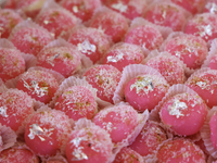 Chum chums, a traditional Indian sweet, are topped with coconut flakes and displayed at a sweet shop for the upcoming festival of Diwali in...