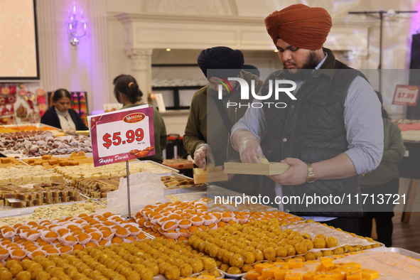 People purchase traditional Indian sweets at a sweet shop for the upcoming festival of Diwali in Mississauga, Ontario, Canada, on October 26...