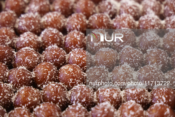 Gulab jamuns (a traditional Indian sweet) topped with coconut flakes are displayed at a sweet shop for the festival of Diwali in Mississauga...