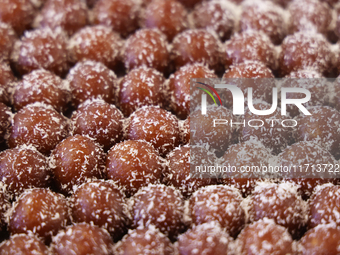 Gulab jamuns (a traditional Indian sweet) topped with coconut flakes are displayed at a sweet shop for the festival of Diwali in Mississauga...