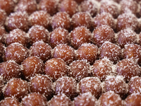 Gulab jamuns (a traditional Indian sweet) topped with coconut flakes are displayed at a sweet shop for the festival of Diwali in Mississauga...