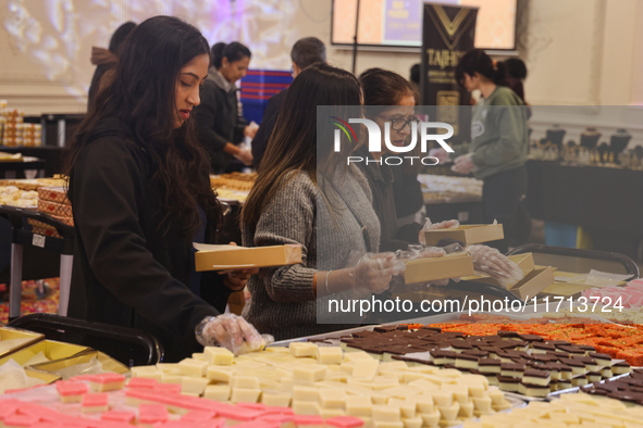 People purchase traditional Indian sweets at a sweet shop for the upcoming festival of Diwali in Mississauga, Ontario, Canada, on October 26...