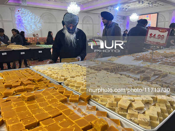 People purchase traditional Indian sweets at a sweet shop for the upcoming festival of Diwali in Mississauga, Ontario, Canada, on October 26...