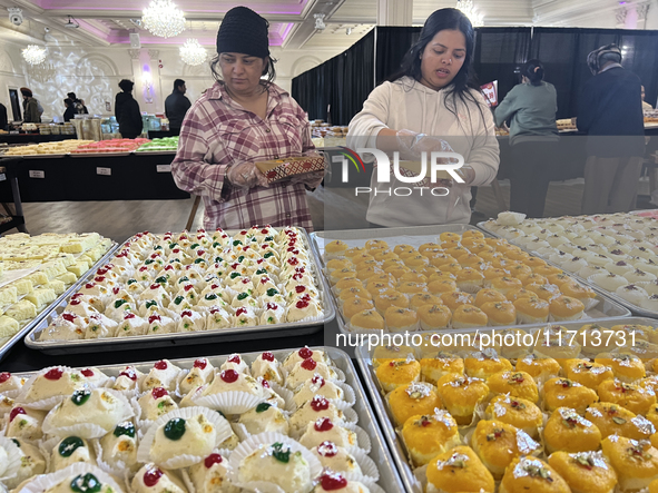 People purchase traditional Indian sweets at a sweet shop for the upcoming festival of Diwali in Mississauga, Ontario, Canada, on October 26...