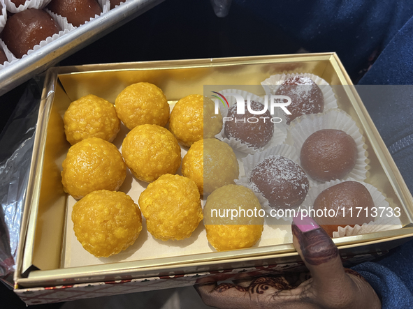 A woman purchases traditional Indian sweets at a sweet shop for the upcoming festival of Diwali in Mississauga, Ontario, Canada, on October...