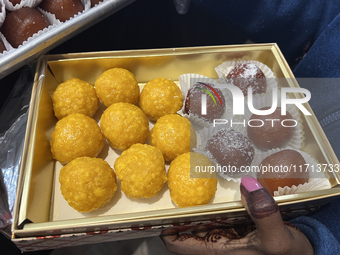 A woman purchases traditional Indian sweets at a sweet shop for the upcoming festival of Diwali in Mississauga, Ontario, Canada, on October...