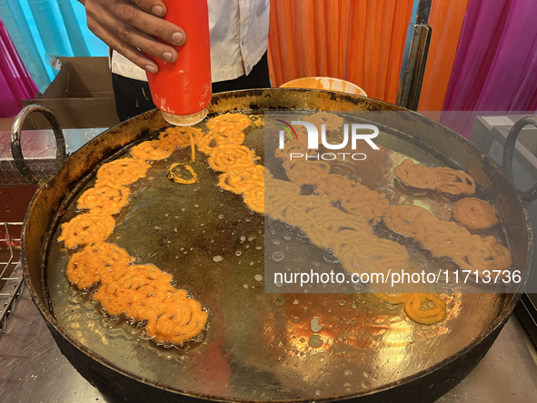 A man fries jalebis (a traditional Indian sweet) at a sweet shop for the upcoming festival of Diwali in Mississauga, Ontario, Canada, on Oct...