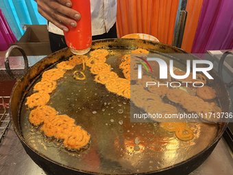 A man fries jalebis (a traditional Indian sweet) at a sweet shop for the upcoming festival of Diwali in Mississauga, Ontario, Canada, on Oct...