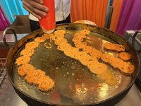 A man fries jalebis (a traditional Indian sweet) at a sweet shop for the upcoming festival of Diwali in Mississauga, Ontario, Canada, on Oct...