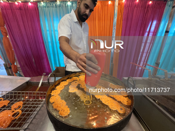 A man fries jalebis (a traditional Indian sweet) at a sweet shop for the upcoming festival of Diwali in Mississauga, Ontario, Canada, on Oct...