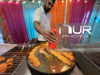 A man fries jalebis (a traditional Indian sweet) at a sweet shop for the upcoming festival of Diwali in Mississauga, Ontario, Canada, on Oct...