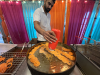 A man fries jalebis (a traditional Indian sweet) at a sweet shop for the upcoming festival of Diwali in Mississauga, Ontario, Canada, on Oct...