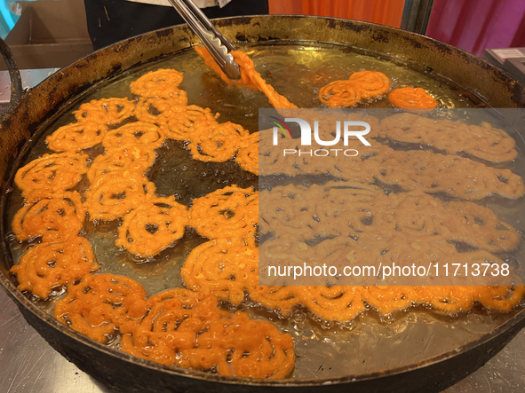 A man fries jalebis (a traditional Indian sweet) at a sweet shop for the upcoming festival of Diwali in Mississauga, Ontario, Canada, on Oct...