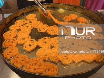 A man fries jalebis (a traditional Indian sweet) at a sweet shop for the upcoming festival of Diwali in Mississauga, Ontario, Canada, on Oct...