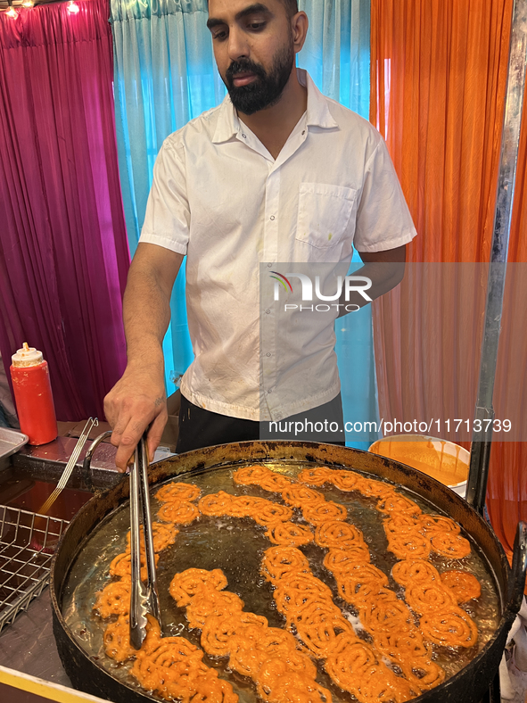 A man fries jalebis (a traditional Indian sweet) at a sweet shop for the upcoming festival of Diwali in Mississauga, Ontario, Canada, on Oct...