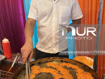 A man fries jalebis (a traditional Indian sweet) at a sweet shop for the upcoming festival of Diwali in Mississauga, Ontario, Canada, on Oct...