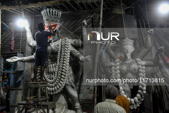 Artisans and workers make idols of Goddess Kali ahead of the Kali Puja festival in Kolkata, India, on October 27, 2024. 