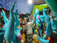 Artisans and workers make idols of Goddess Kali ahead of the Kali Puja festival in Kolkata, India, on October 27, 2024. (