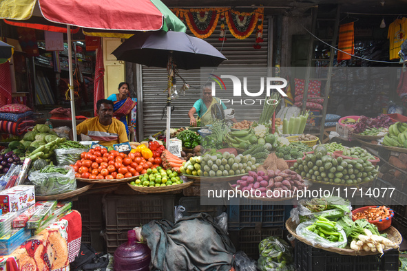 Vendors sell vegetables inside a market in Kolkata, India, on October 27, 2024. 