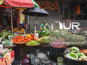 Vendors sell vegetables inside a market in Kolkata, India, on October 27, 2024. (