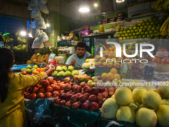 A woman buys fruits inside a market in Kolkata, India, on October 27, 2024. (