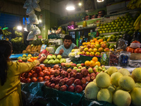 A woman buys fruits inside a market in Kolkata, India, on October 27, 2024. (