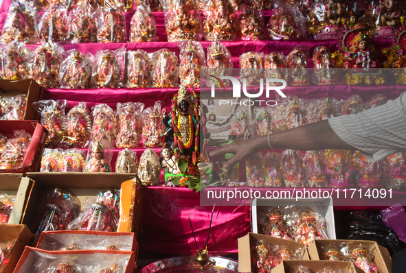 A shopkeeper worships the Hindu goddess Kali at his stall inside a market in Kolkata, India, on October 27, 2024. 