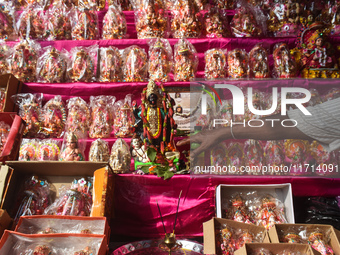 A shopkeeper worships the Hindu goddess Kali at his stall inside a market in Kolkata, India, on October 27, 2024. (