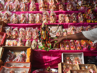 A shopkeeper worships the Hindu goddess Kali at his stall inside a market in Kolkata, India, on October 27, 2024. (