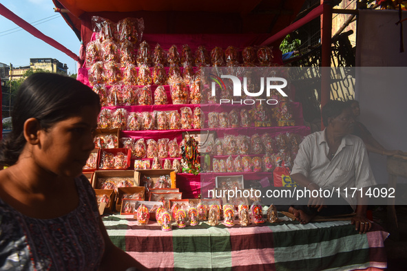 A shopkeeper sells Hindu goddess Laxmi and Ganesh for the upcoming Diwali festival inside a market in Kolkata, India, on October 27, 2024. 