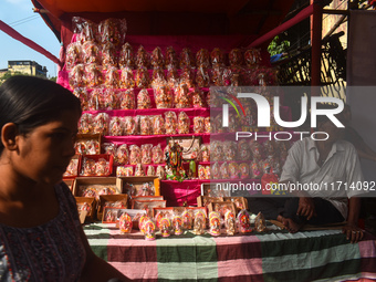 A shopkeeper sells Hindu goddess Laxmi and Ganesh for the upcoming Diwali festival inside a market in Kolkata, India, on October 27, 2024. (