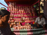 A shopkeeper sells Hindu goddess Laxmi and Ganesh for the upcoming Diwali festival inside a market in Kolkata, India, on October 27, 2024. (