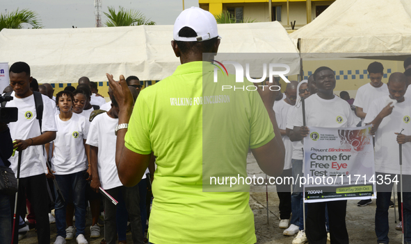 Officials and trainees of the Vocational Training Centre, Federal Nigeria Society for the Blind, Oshodi, participate in a sensitization walk...