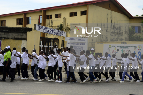 Officials and trainees of the Vocational Training Centre, Federal Nigeria Society for the Blind, Oshodi, participate in a sensitization walk...