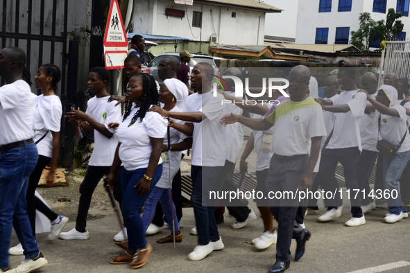 Officials and trainees of the Vocational Training Centre, Federal Nigeria Society for the Blind, Oshodi, participate in a sensitization walk...