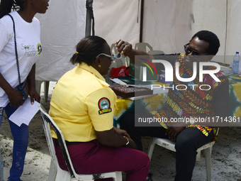 A Lagos State traffic official undergoes eye screening as the Federal Nigeria Society for the Blind organizes a walk and conducts free eye s...