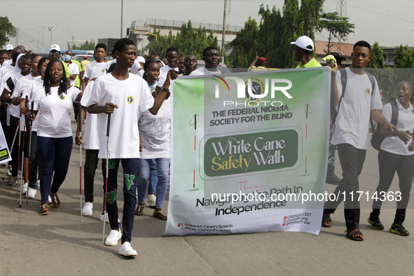 Officials and trainees of the Vocational Training Centre, Federal Nigeria Society for the Blind, Oshodi, participate in a sensitization walk...